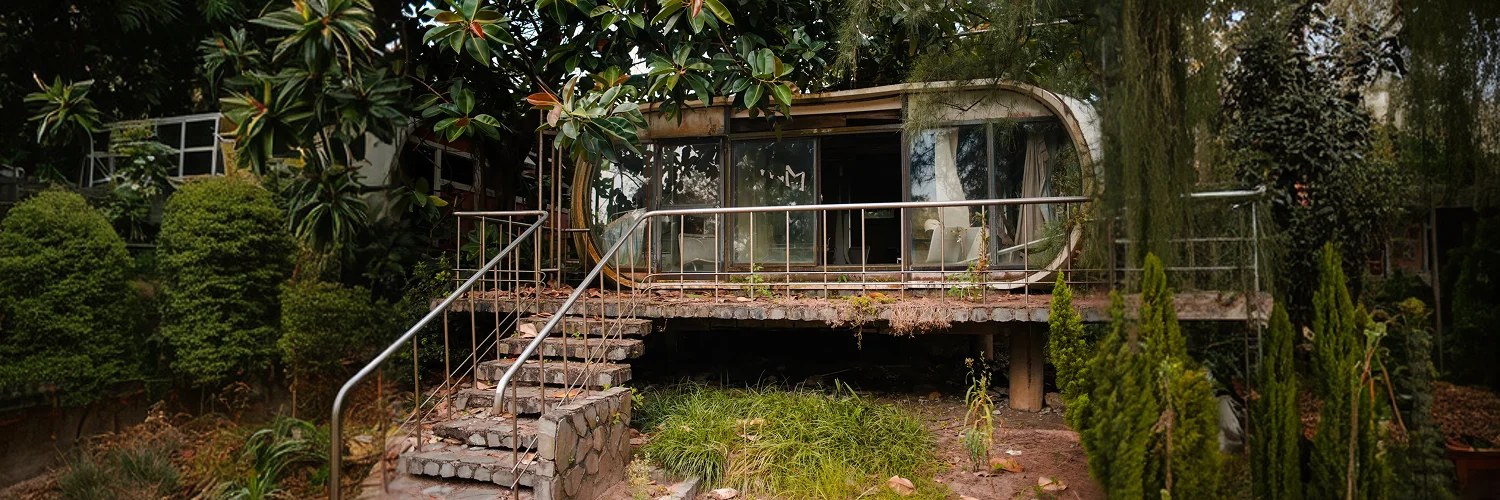 abandoned-old-building-with-glass-windows-garden-wanli-ufo-village-taiwan 1.webp